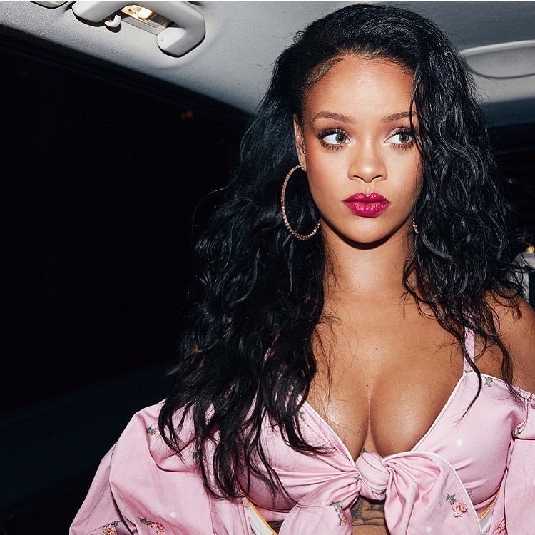 Rihanna with cleavage popping out of her shirt