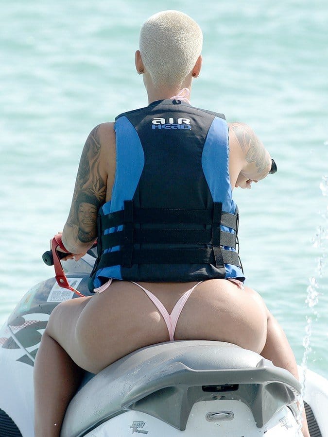 Amber in a string bikini showing off her big butt